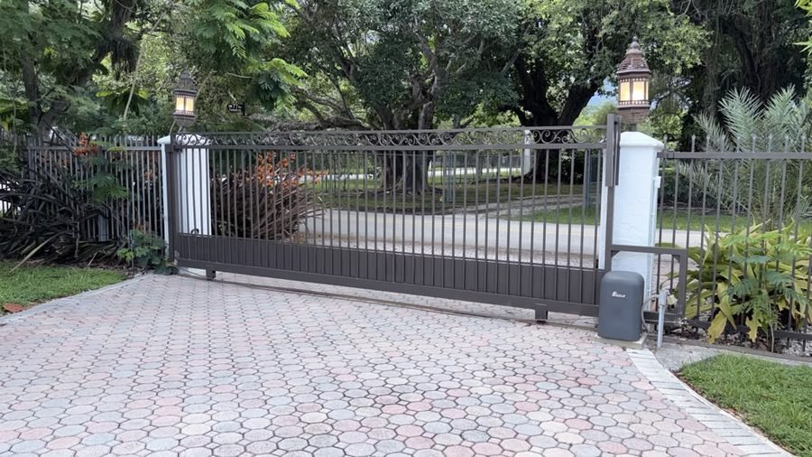 Sliding driveway gate with its operator at the post, serviced by our crew