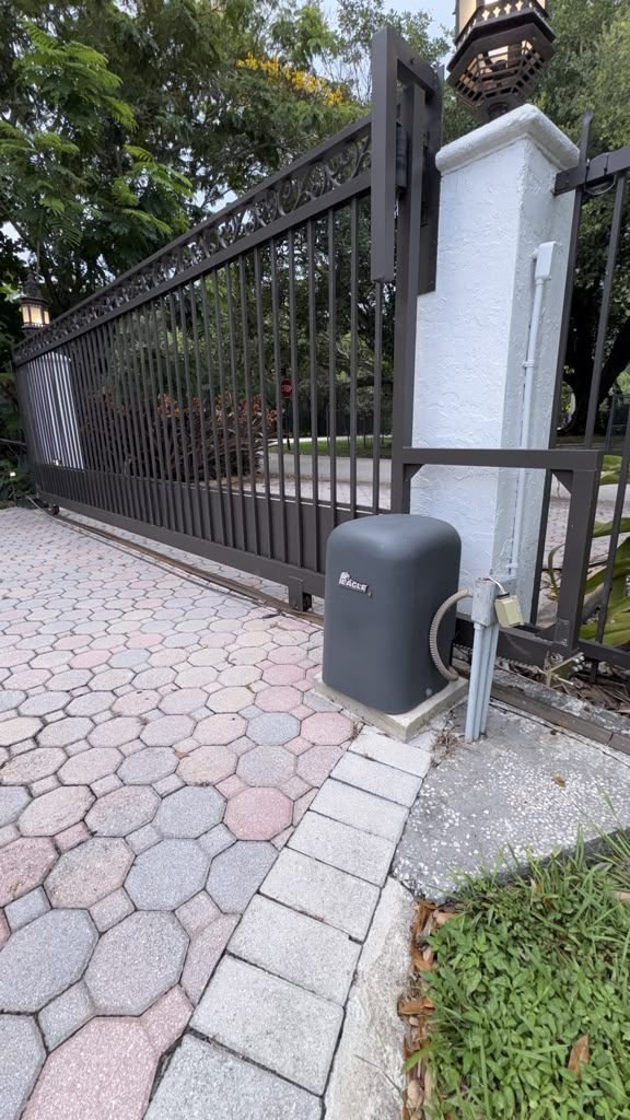 Gate operator mounted at the post of a sliding driveway gate